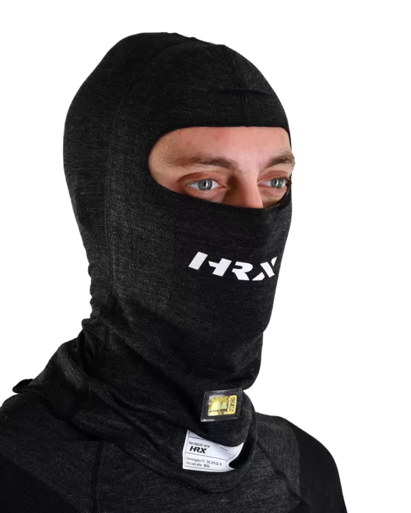 a close up shot of a hrx model wearing the Icon Nomex balaclava